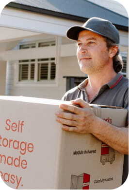 Team member carrying a storage box